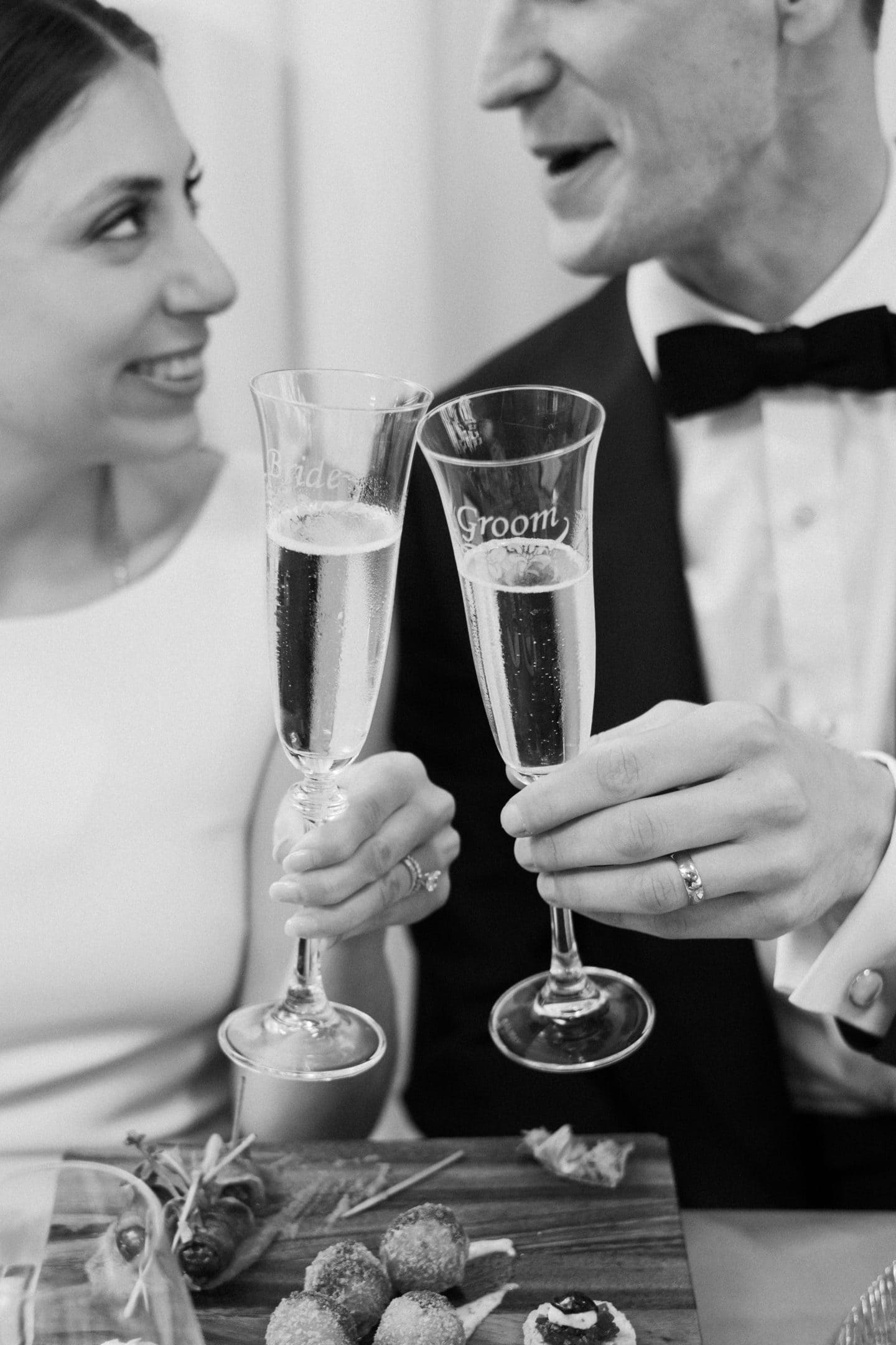 Bride and groom clinking champagne glasses at the highlands in detroit